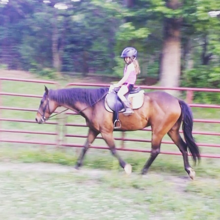 My 6 year old trotting on Thunder by herself for the first time.